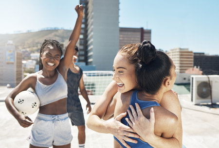 Soccer, rooftop and women hug in city celebrating winning goal in match or game. Smile, happy and...
