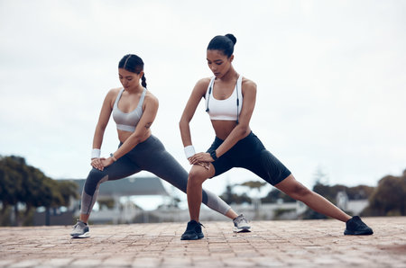 Fitness, city workout and women stretching together before marathon running. Health, wellness and...