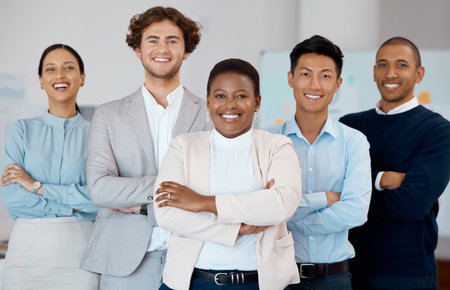 Corporate, smile and employees in business collaboration together in an office at work. Portrait of team with diversity, arms crossed and pride in partnership while working at a professional companyの写真素材