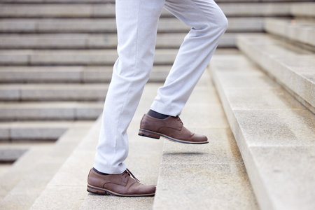 This is the way to success. a unrecognizable male walking on a staircase outside.の写真素材