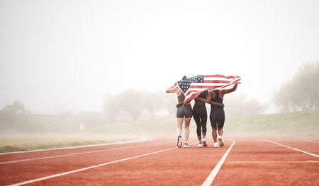 Building a successful team from the ground up. a sports team holding the american flag.の写真素材