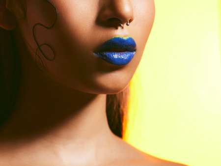 Its the mouth that proves just how bold we are. Studio shot of a beautiful young woman wearing blue lipstick.の写真素材