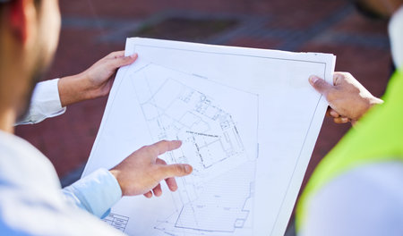Could we possibly extend. an unrecognisable group of architects standing together and looking at a...
