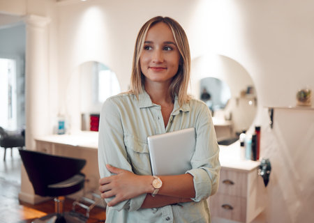 Hairdresser salon, happy and woman with tablet to check digital schedule, calendar or work day planner. Hair care, beauty studio and barbershop worker with mobile tech checklist to track inventoryの写真素材