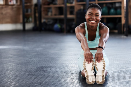 I enjoy taking care of my body. a fit young woman stretching at the gym.
