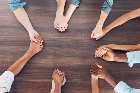 Top view, holding hands or mental health support in group therapy meeting for psychology, trust or...