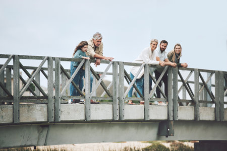 Big family, bridge and happy travel, vacation or holiday trip together outdoors. Family, generations and mom, dad and girl, grandma and grandpa spending time together, love and bonding in Canada.の写真素材