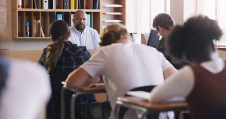 You have 30 minutes to write your test. teenagers writing an exam in a classroom.の写真素材