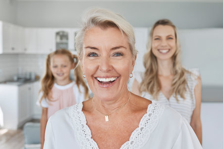 Senior, retirement and family with a grandmother, woman and girl in their home together during a visit. Happy, smile and generations with an elderly female pensioner and her relatives in a houseの写真素材