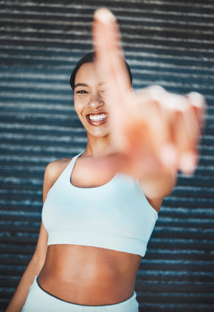Fitness, exercise and finger frame woman out for a run, running and cardio workout in city for health, wellness and energy. Smile of athlete female ready for sports training or outdoor running in USAの写真素材