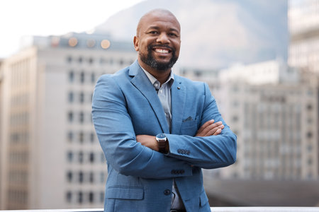 The boss always does it best. Portrait of a confident mature businessman standing with his arms crossed on a balcony outside an office.の写真素材