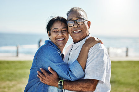 Love, hug and happy senior couple enjoy romantic quality time together, travel vacation or bond on outdoor grass field. Happiness, partnership and elderly man, woman or people smile on Mexico holidayの写真素材