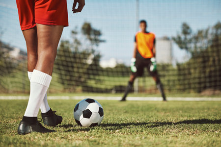 Sports, soccer field and legs of athlete with goalkeeper ready for penalty kick, game or competition for fitness health. Football player, ball or man prepare for outdoor workout, training or exerciseの写真素材