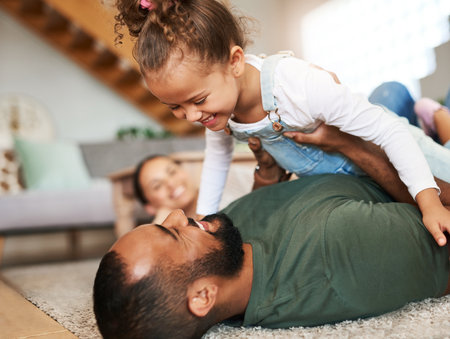Our lives shine brighter now with you here. a happy family having fun together at home.の写真素材