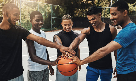 Training, friends and community support by basketball players hand connected in support of sports goal and vision. Fitness, trust and motivation on basketball court by happy, united professional menの写真素材
