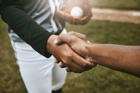 Baseball players handshake before game at baseball field for good luck, agreement and support. Sports, fitness and athletes shaking hands to show unity, well wishes and hope for success during matchの写真素材