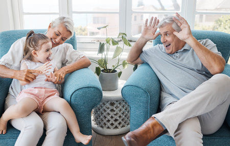 Happy, grandfather and grandmother with child, excited and bonding being silly, goofy or funny in...