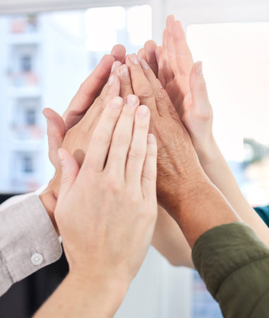 Motivate your team members to be their best. a group of colleagues high fiving each other.