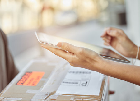 We just need your signature please. a female customer signing for her delivery using a digital tablet.の写真素材