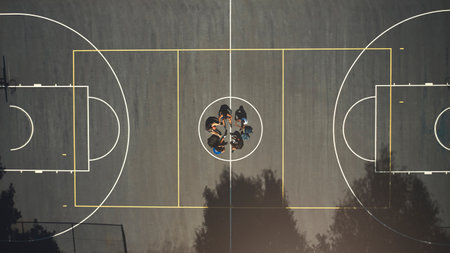 Top view, basketball court or men in training break circle for game strategy, college match planning or target goal collaboration. Basketball players, sports team or community fitness in workout restの写真素材