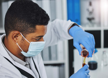 I have to be very precise. a young male researcher working in a laboratory.