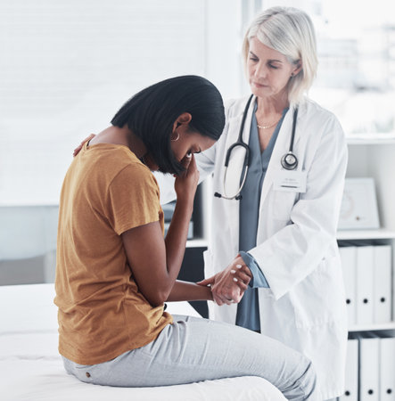 It might be difficult but well do it together. a doctor consoling an unhappy patient during a consultation.の写真素材