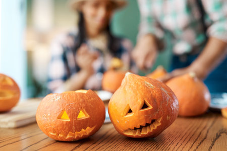 The result of our hard work. a young couple carving pumpkins at home.の写真素材
