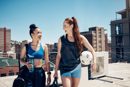 Women go to sports training with ball, rooftop city sports in Colombia or walking to football game....