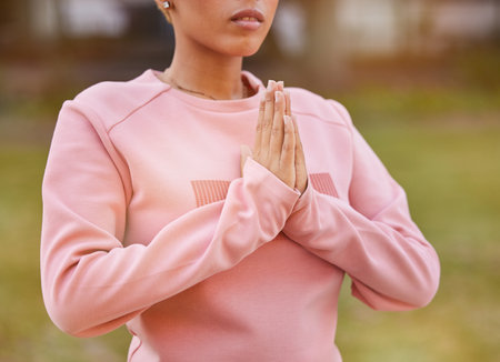 Hands, yoga and meditation with a woman in a park for mental health, wellness and calm closeup. Zen, serene and peace with a female meditating outdoor for holistic or spiritual health and faithの写真素材
