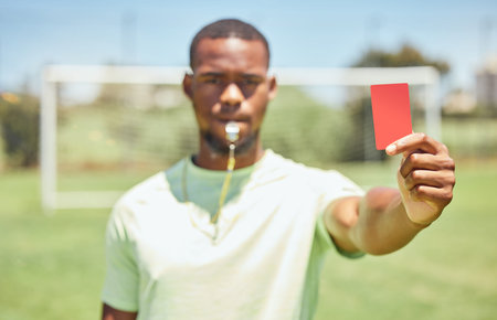 Soccer, referee and red card on the field during a sports match or training for fitness. Workout,...