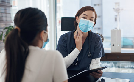 Does it feel swollen. a young female doctor talking to a patient in an office.