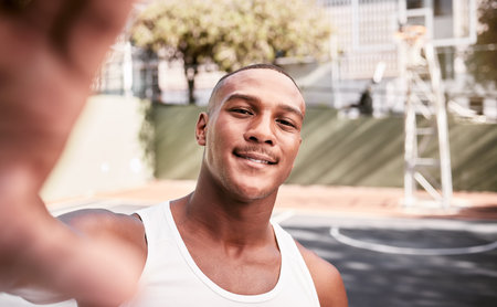 Sports, smile and man taking a selfie on a basketball court after fitness training, cardio exercise and workout. Smile, portrait and happy black man taking pictures or photo outdoors in Chicago, USAの写真素材