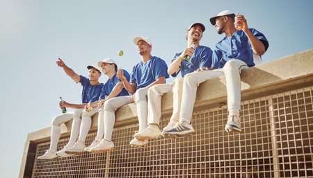 Baseball, team and baseball player, sports men together and health with fitness, diversity and group on a break. Young, athlete and happy, fruit and drink for nutrition, hydration and fun at game.の写真素材