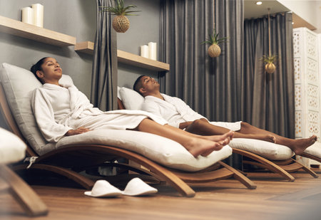 Call your local spa and book yourself in for a treat. a young couple spending the day together at a spa.の写真素材
