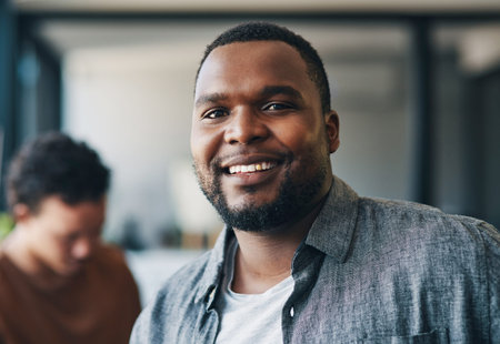 Your smile is your best feature. a young businessman smiling in an office.の写真素材