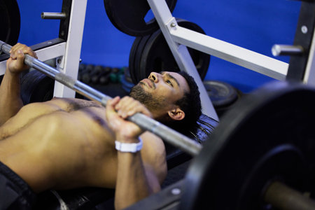 These biceps wont build themselves. a young man doing press ups during his workout routine at the...