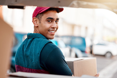 Logistics, smile and man with box at van looking back, trust and success in courier service for ecommerce business. Supply chain, cargo and stock distribution, delivery driver at truck with package.の写真素材