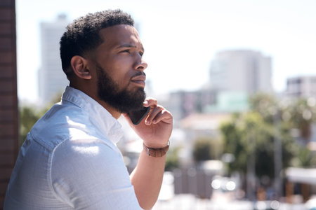Doing what it takes to reach his full potential. a young businessman talking on a cellphone while...