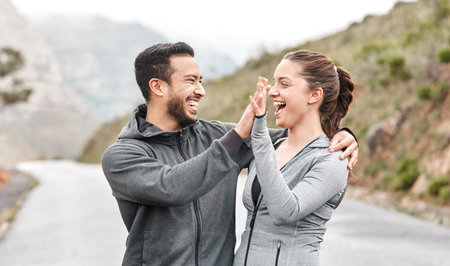 Healthy habits make them the happiest. a sporty young man and woman giving each other a high five...