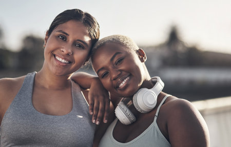 Best friends support each other through everything. two friends out for a workout together.の写真素材