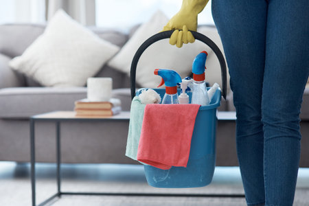 These floors are about to shine. an unrecognizable woman holding a bucket of cleaning detergent...