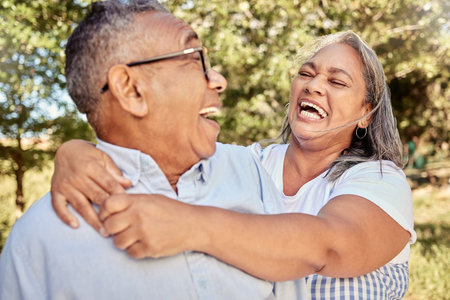 Happy, love and laugh with a senior couple having fun in a garden or park together during summer....