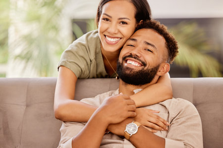 Smile, love and portrait of couple on sofa for happy, support and hug together with connection. Relax, partner and peace with man and woman in living room at home for marriage, relationship and careの写真素材