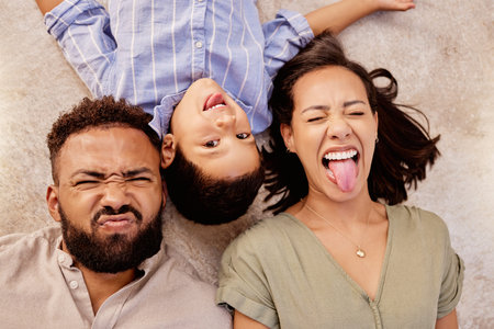 Floor, family and fun on a carpet in living room with cheerful, silly and playful people showing...