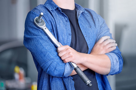 Mechanic with socket wrench, car maintenance and man in workshop for auto repair and mechanical...