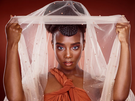Beauty is what you make of it. Cropped portrait of an attractive young woman posing in studio against a red background.の写真素材