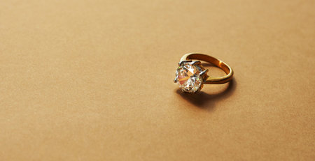 Shes bound to say yes with that beauty. Studio shot of a gold ring with a diamond against a brown...
