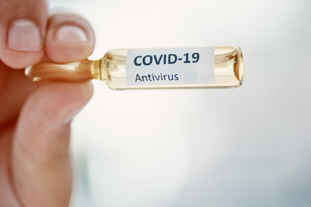 The official game changer. a scientist holding an ampoule with 2019-nCov on it.