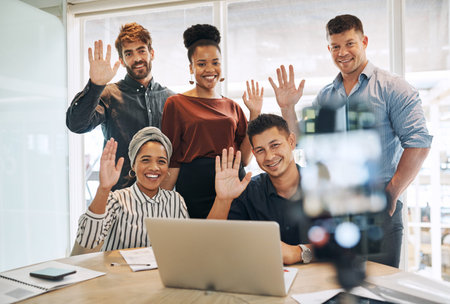 Distance and timezones wont stop us from reaching success. a group of businesspeople waving while...