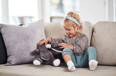 Youre going to sit right there. Full length shot of an adorable little girl sitting alone on the...